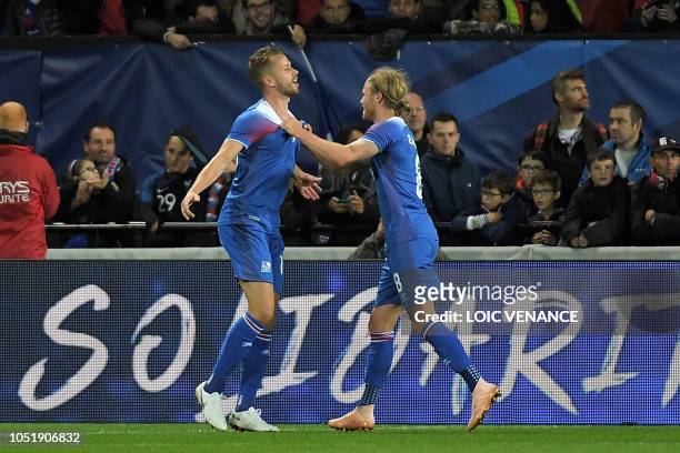 Iceland's defender Kari Arnason celebrates with Iceland's midfielder Birkir Bjarnason during the friendly football match between France and Iceland...