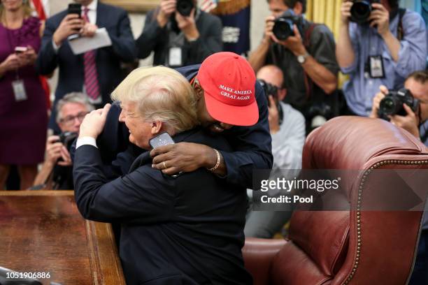 Rapper Kanye West hugs U.S. President Donald Trump during a meeting in the Oval office of the White House on October 11, 2018 in Washington, DC.