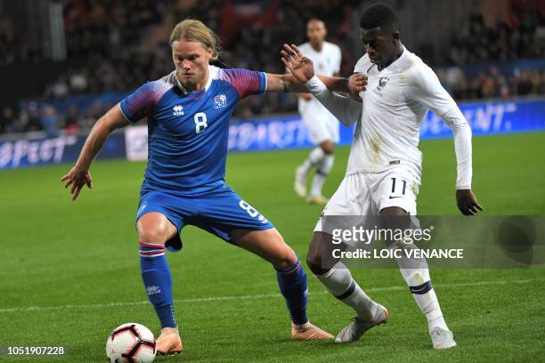 Iceland's midfielder Birkir Bjarnason vies with France's forward Ousmane Dembele during the friendly football match between France and Iceland at the...