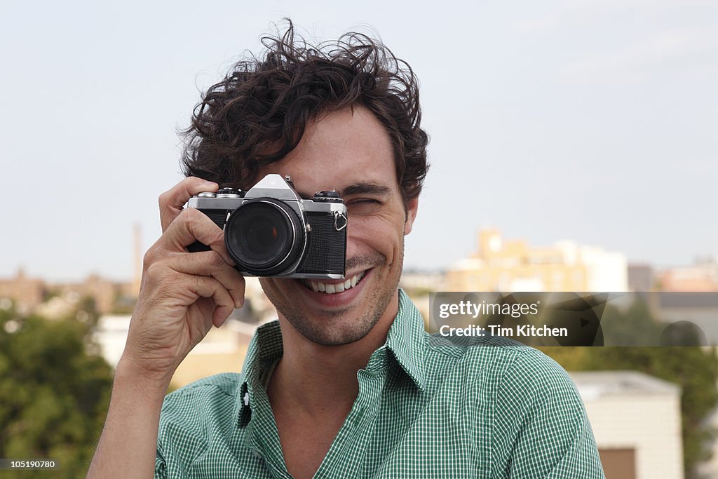Man taking picture, smiling