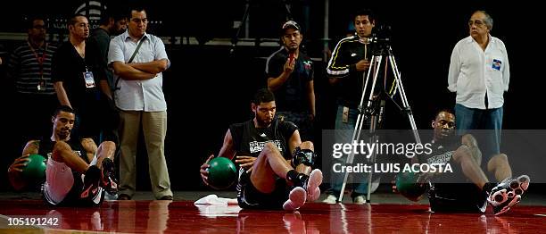 San Antonio Spurs players Marcus Cousin , Tim Duncan and James Anderson, make exercises during in a training session in Mexico City on October 11,...
