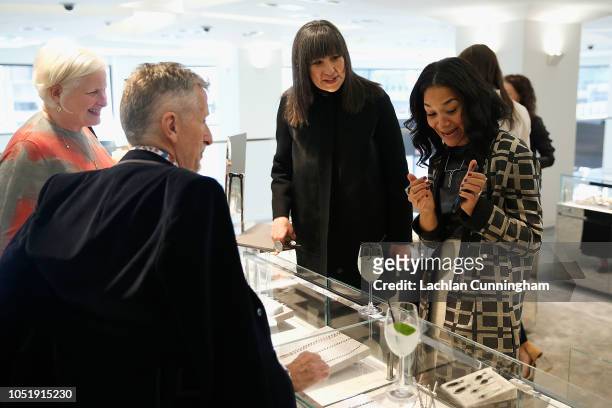 Monique Pean shows her jewelry to guests during a celebration in support of UCSF Benioff Children's Hospital at Freds at Barneys New York on October...