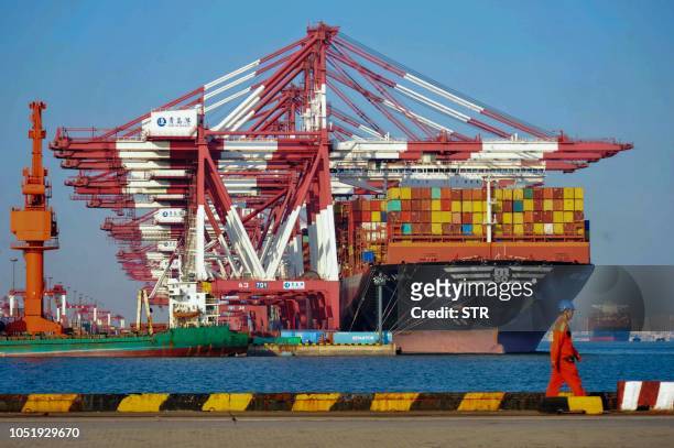 Cargo ship is seen at a port in Qingdao in China's eastern Shandong province on October 12, 2018. - China's trade surplus with the United States...