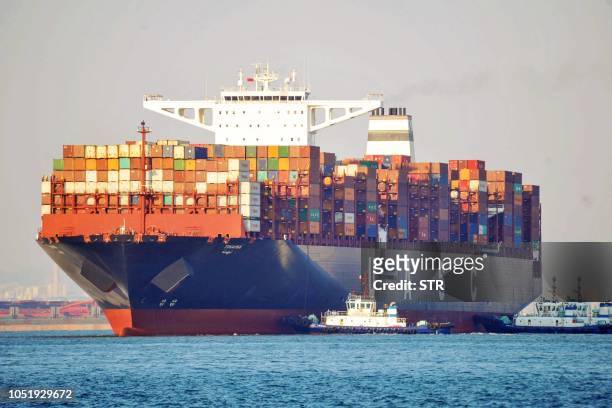 Cargo ship is seen at a port in Qingdao in China's eastern Shandong province on October 12, 2018. - China's trade surplus with the United States...