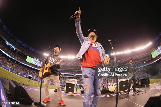 Chris Lucas and Preston Brust of LoCash perform in the rain at halftime of the Philadelphia Eagles vs New York Giants game at MetLife Stadium on...