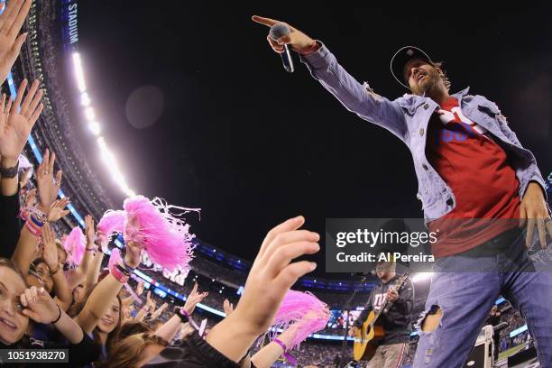 Chris Lucas and Preston Brust of LoCash perform in the rain at halftime of the Philadelphia Eagles vs New York Giants game at MetLife Stadium on...