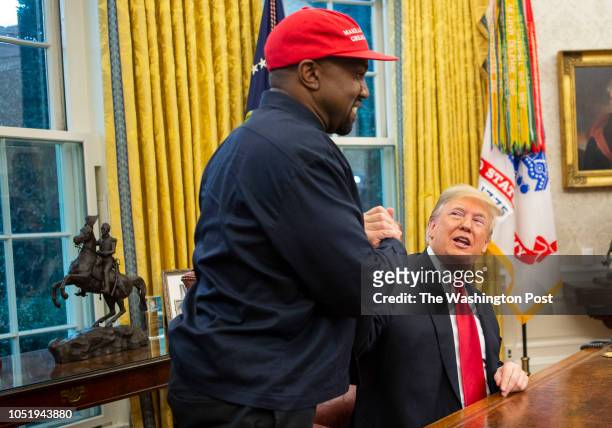 President Donald Trump and rapper Kanye West embrace in the Oval Office of the White House in Washington D.C. On October 11, 2018.