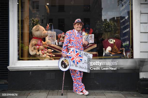 Royal fan Terry Hutt dresses up in the Union Jack flag holding a sign of congratulations ahead of the Royal wedding of Princess Eugenie of York and...