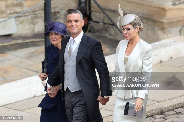 British singer-songwriter Robbie Williams arrives with his wife US actress Ayda Field to attend the wedding of Britain's Princess Eugenie of York to...