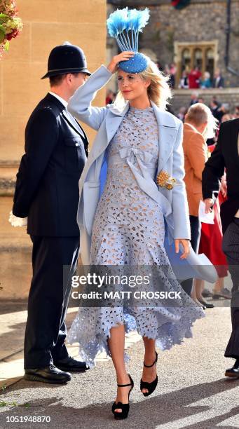 Poppy Delevingne arrives to attend the wedding of Britain's Princess Eugenie of York to Jack Brooksbank at St George's Chapel, Windsor Castle, in...