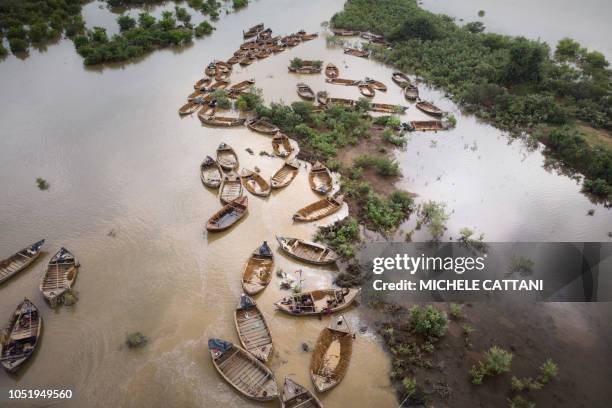 An aerial view shows Malian diggers loading boats with sand collected from the Niger River near Kangaba, in Mali's southwestern Koulikoro region, on...