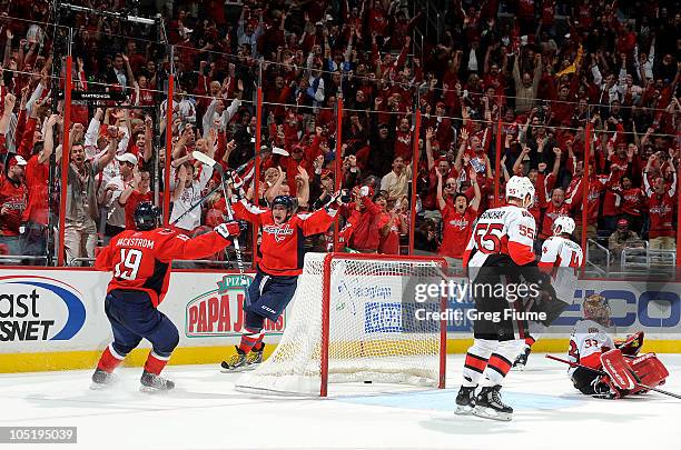 Alex Ovechkin of the Washington Capitals celebrates with Nicklas Backstrom after scoring the winning goal in overtime against Pascal Leclaire of the...