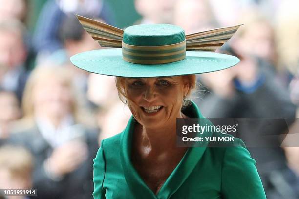 Sarah, Duchess of York arrives to take her seat inside St George's Chapel ahead of the wedding of her daughter Britain's Princess Eugenie of York to...
