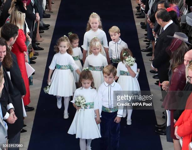 The bridesmaids and page boys, including Princess Charlotte and Prince George walk down the aisle following the wedding of Princess Eugenie of York...