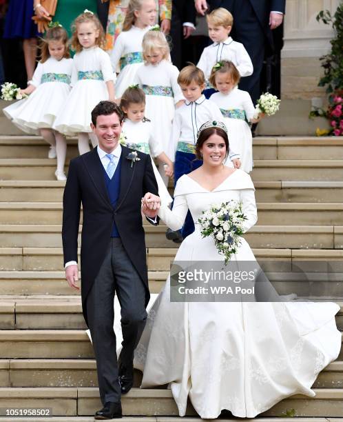 Princess Eugenie of York of York and her husband Jack Brooksbank leave after their wedding at St George's Chapel in Windsor Castle on October 12,...