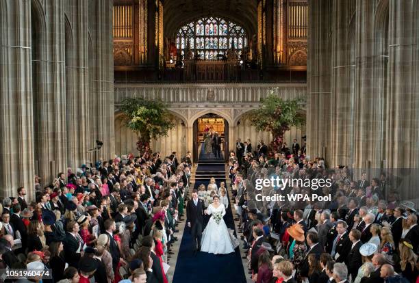 Princess Eugenie and Jack Brooksbank walk down the aisle following their marriage at St George's Chapel in Windsor Castle on October 12, 2018 in...