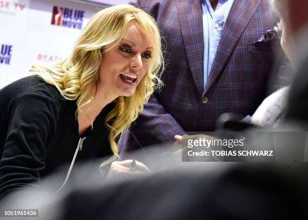 Adult film actress Stormy Daniels signs autographs at the Venus Fair for Erotic Entertainment and Lifestyle on October 12, 2018 in Berlin. - Daniels...