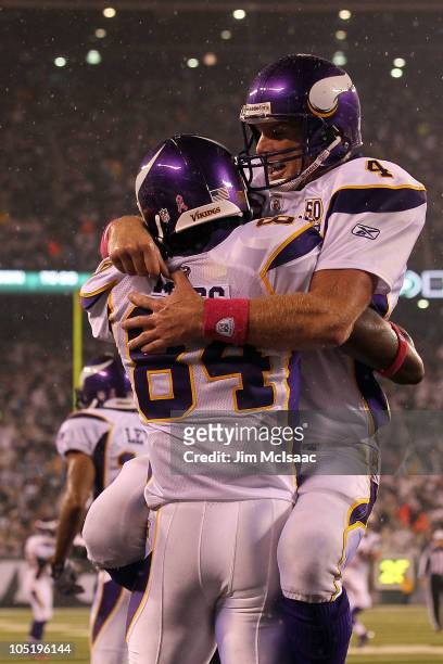 Brett Favre and Randy Moss of the Minnesota Vikings celebrate after Moss caught a 37-yard touchdown pass from Favre in the third quarter against the...