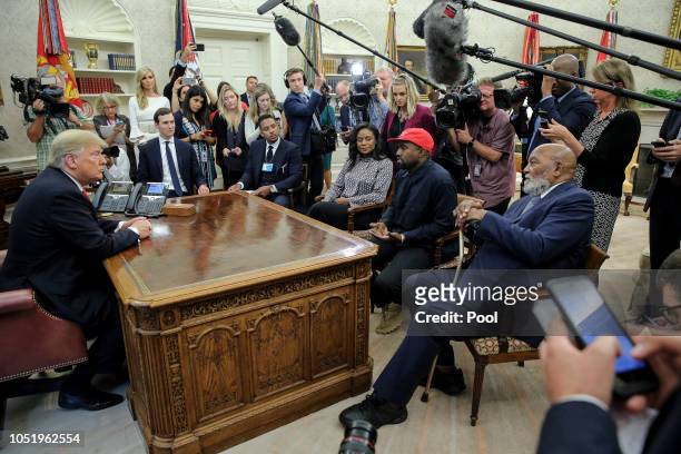 Rapper Kanye West, second right, flanked by NFL Hall of Famer Jim Brown, right, speaks during a meeting with President Donald Trump, left, in the...