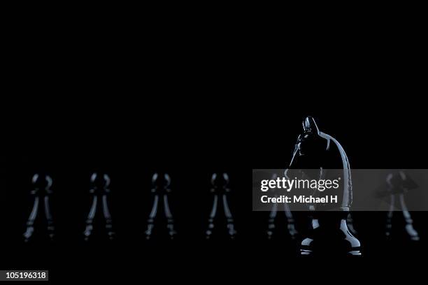 black knight who stands ahead of row of pawn - chess pieces stock pictures, royalty-free photos & images