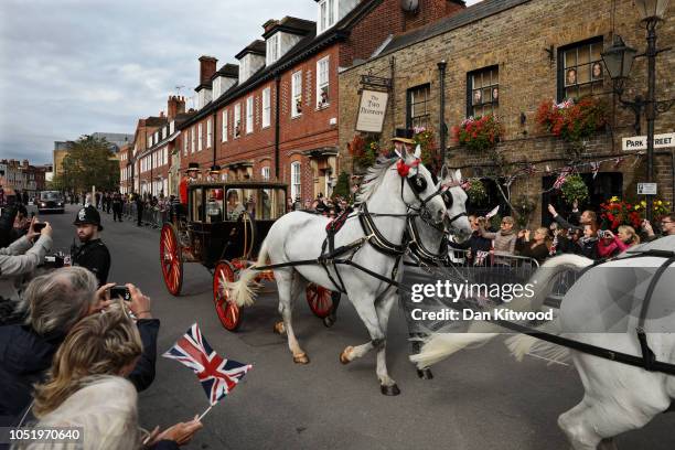 Newlyweds Princess Eugenie of York and Mr. Jack Brooksbank wave to the crowds from their carriage after their Royal wedding at St. George's Chapel on...