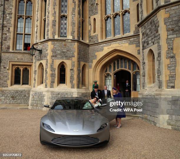 Princess Eugenie and Jack Brooksbank helped by Princess Beatrice and Prince Andrew, Duke of York leave Windsor Castle in an Aston Martin DB10 after...