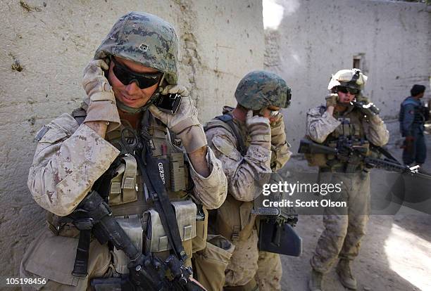 Marines attached to India Battery, 3rd Battalion, 12th Marine Regiment cover their ears as a 500 pound bomb is dropped on an enemy position during a...