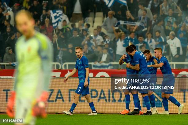 Greece's Kostas Mitroglou celebrates with his teammates after scoring against Hungary during the UEFA Nations League football match between Greece...