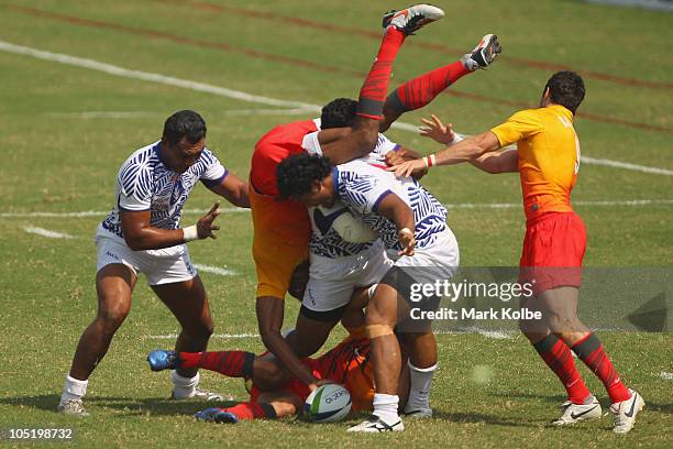 Isoa Damudamu of England is up-ended at the ruck during the rugby 7's quarter final match between England and Samoa at Delhi University during day...