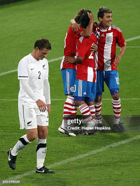 Ben Sigmund of the All Whites looks dejected as Enrique Vera, Osvaldo Martinez and Edgar Benitez of Paraguay celebrate a goal during the...