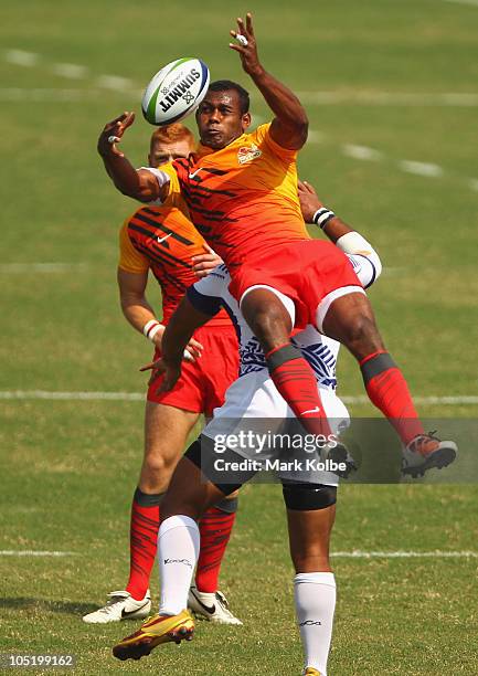 Isoa Damudamu of England wins the ball during the rugby 7's quarter final match between England and Samoa at Delhi University during day nine of the...