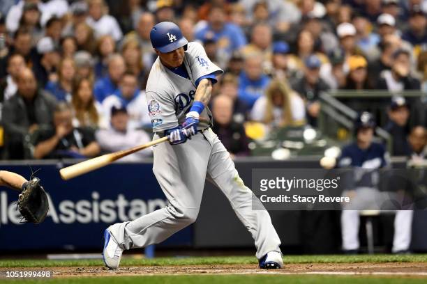 Manny Machado of the Los Angeles Dodgers hits a solo home run against Gio Gonzalez of the Milwaukee Brewers during the second inning in Game One of...