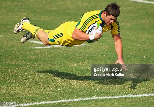 Liam Gill of Australia dives over to score a try during the rugby 7's semifinal match between Australia and South Africa at Delhi University during...