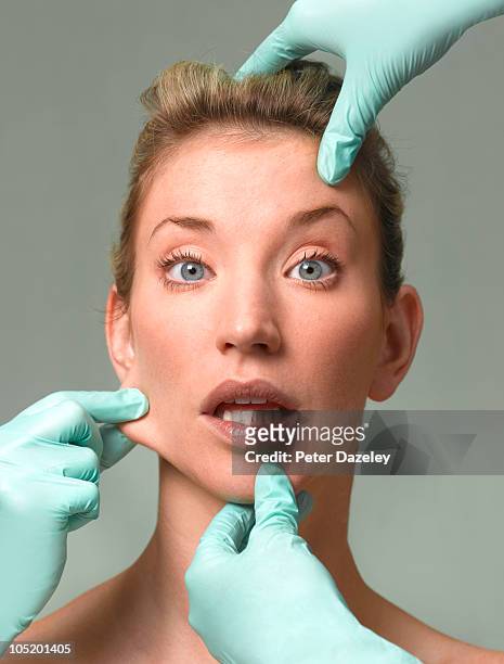 woman's face being pulled for plastic surgery - pull a face foto e immagini stock