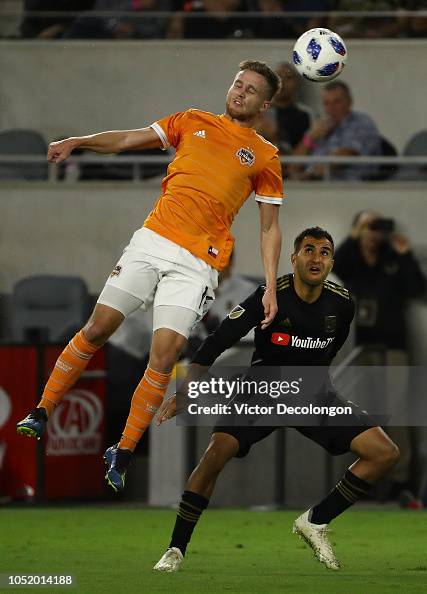 Adam Lundqvist of Houston Dynamo heads the ball as Steven Beitashour