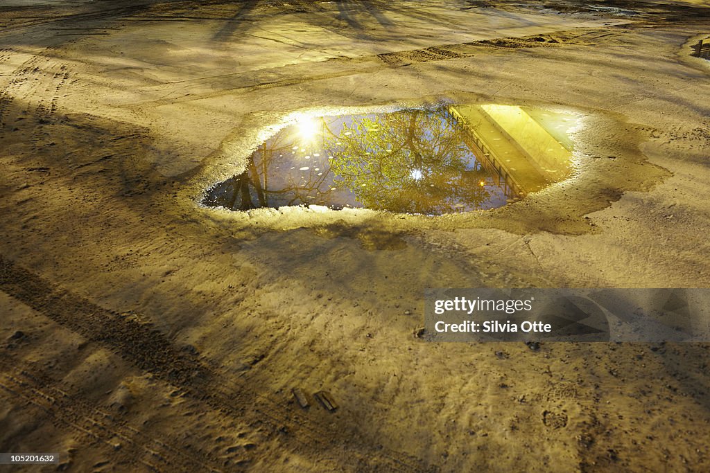Puddle with reflection of railway underpath