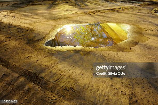 puddle with reflection of railway underpath - puddle ストックフォトと画像