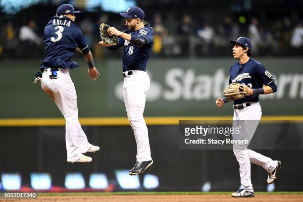 Ryan Braun, Orlando Arcia Christian Yelich of the Milwaukee Brewers celebrate after defeating the Los Angeles Dodgers in Game One of the National...