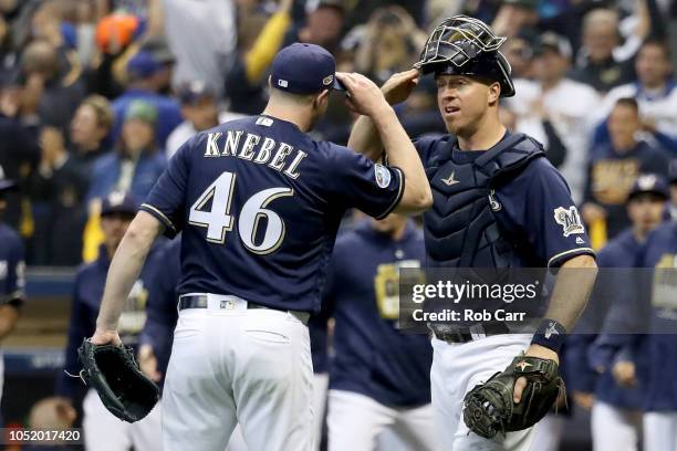 Corey Knebel and Erik Kratz of the Milwaukee Brewers celebrate after defeating the Los Angeles Dodgers in Game One of the National League...