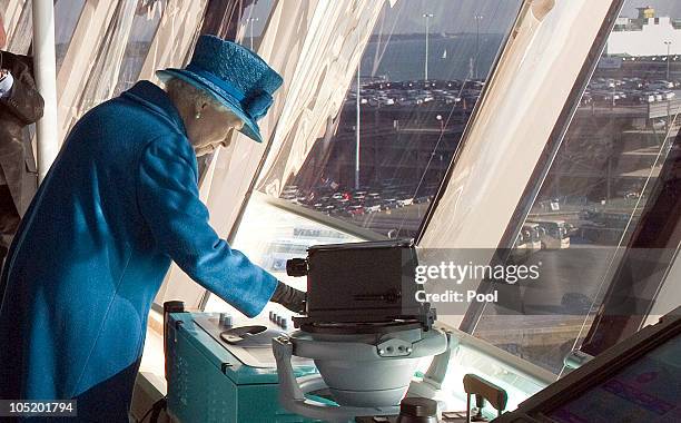 Queen Elizabeth II presses the ship's siren during a tour of the Cunard's new cruise-liner Queen Elizabeth II in Southampton Docks on October 11,...