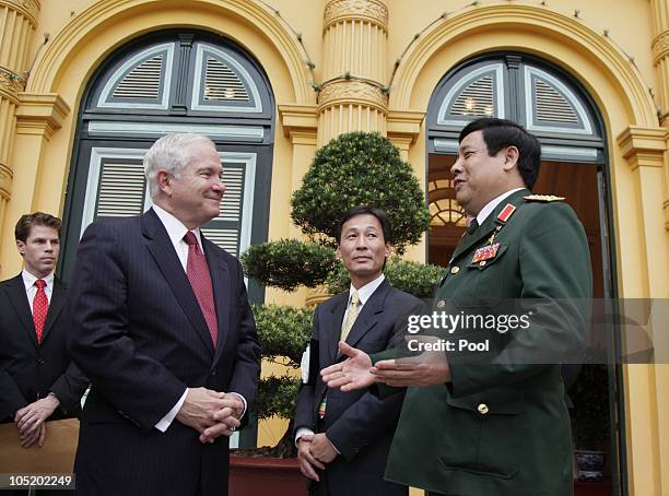 Defence Secretary Robert Gates and Vietnamese Minister of Defense General Phung Quang Thanh talk outside the Presidential Palace as they attend a...