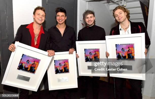 Seconds of Summer band members Luke Hemmings, Calum Hood, Michael Clifford and Ashton Irwin are presented with plaques to commemorate 1 million...