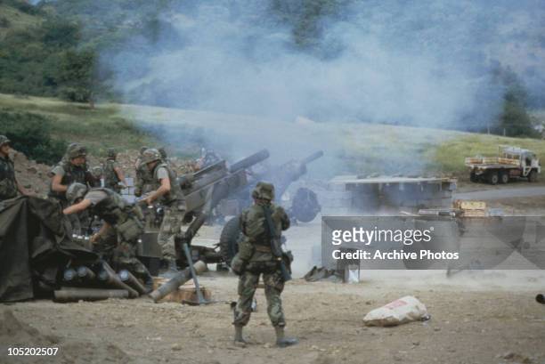 Troops of the 82nd Airborne artillery firing M102 howitzers during the US invasion of Grenada, 3rd November 1983. The invasion was codenamed...