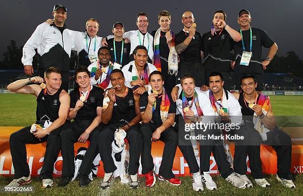 The New Zealand team pose with their gold medals as they celebrate winning the rugby 7's Gold Medal match between New Zealand and Australia at Delhi...