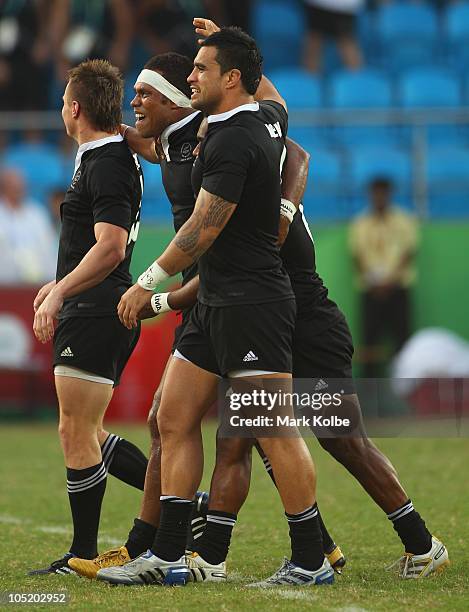 Lote Raikabula and Liam Messam of New Zealand celebrate with their team mates after winning the rugby 7's Gold Medal match between New Zealand and...