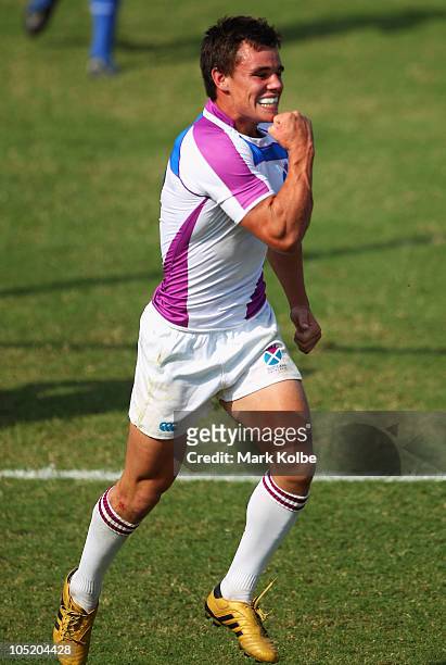Lee Jones of Scotland celebrates scoring the winning try in golden point extra time during the rugby 7's match between Kenya and Scotland at Delhi...