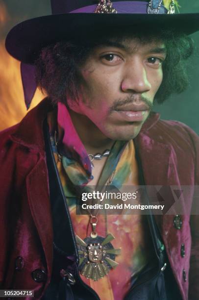 American guitarist and singer Jimi Hendrix , photographed amid smoke and flames, for his album 'Electric Ladyland', London, 1968.