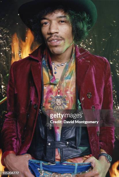 American guitarist and singer Jimi Hendrix , photographed amid smoke and flames, for his album 'Electric Ladyland', London, 1968.