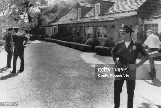 Policemen stand guard outside the home of film director Roman Polanski in west Los Angeles, following the murder of his wife Sharon Tate, and four...