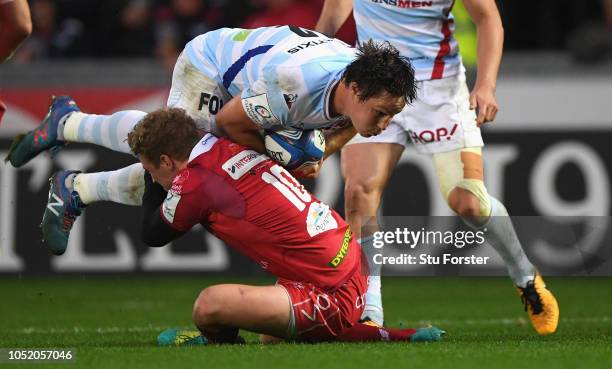 Racing centre Henry Chavancy is tackled by Scarlets player Angus O' Brien during the Champions Cup match between Scarlets and Racing 92 at Parc y...